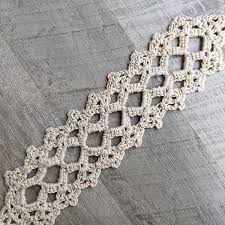 Crochet lace table runner with floral motifs