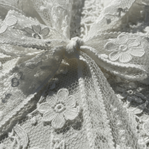 Close-up of white floral pattern net lace trim